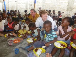 Ken McGrath and Brant Doner provide meals to the children in the refugee camp for Christmas.